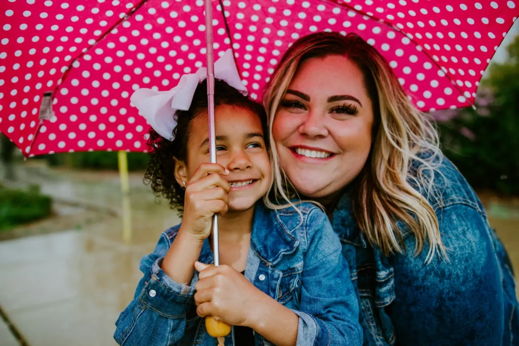 Woman and young child under umbrella