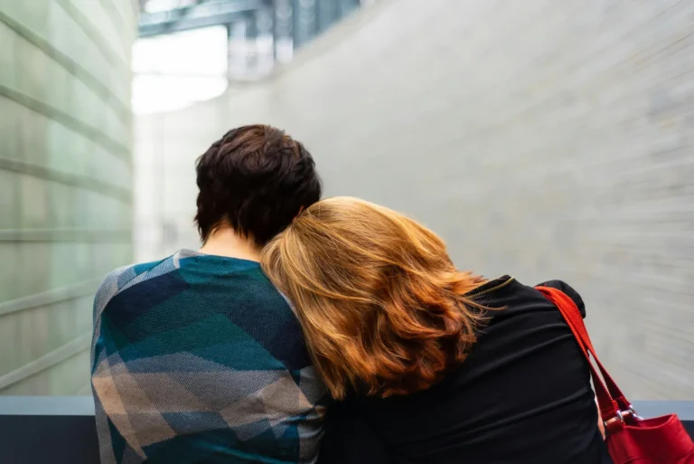 Woman resting her head on partner's shoulder