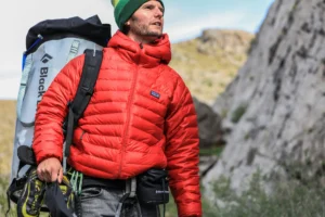 Man with backpack preparing to climb a mountain