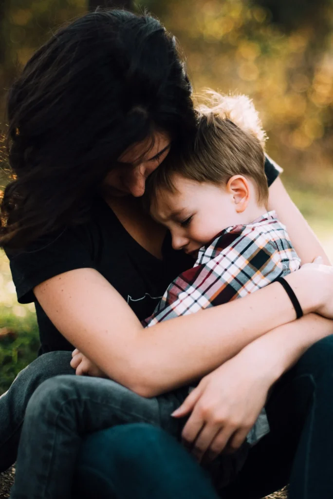 Mother comforting young boy who is upset