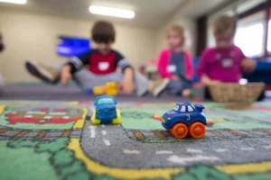 Children playing together with toy cars